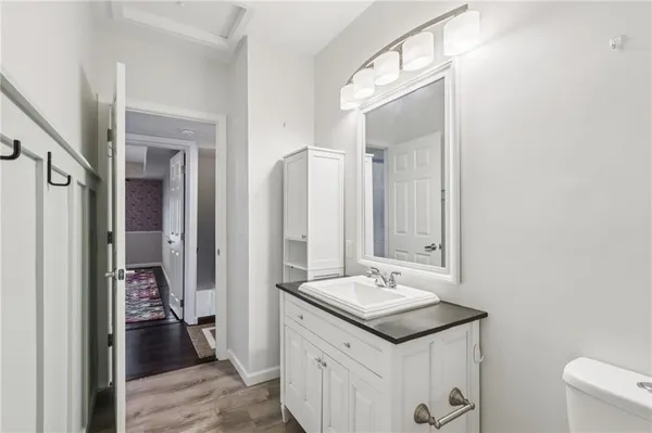 a bathroom with a sink a toilet and a mirror