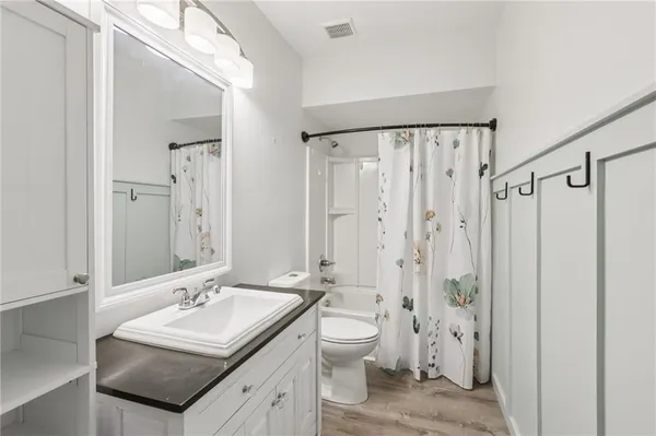a bathroom with a double vanity sink toilet and shower