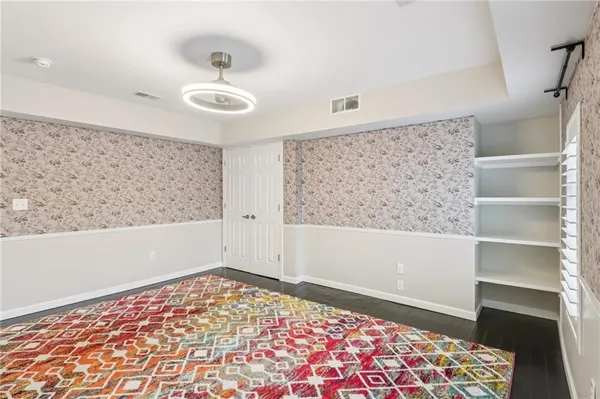 a view of a big room with wooden floor and windows