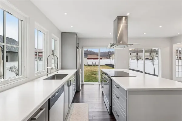 a kitchen with a sink stove and cabinets