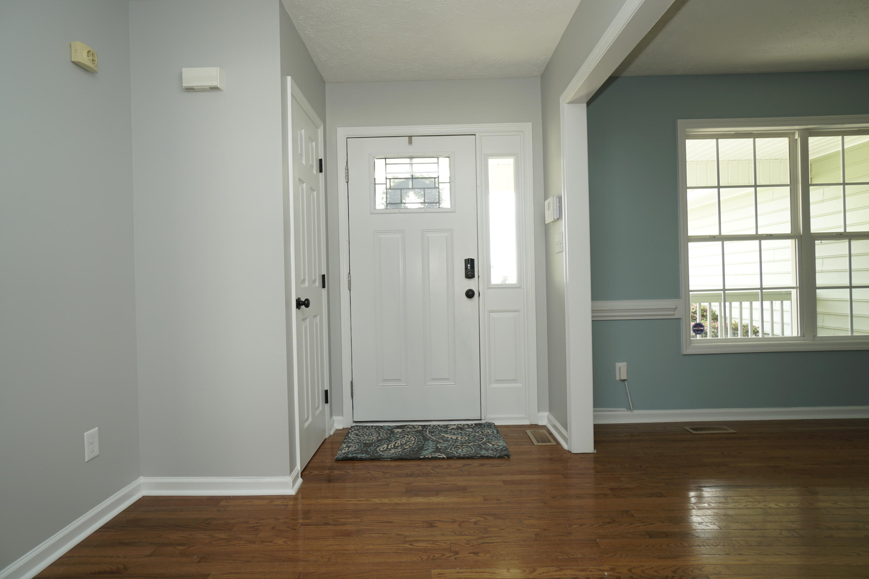 107 Cherian Court Pooler, GA 31322 - Photo 18 of 50 Leaving the living room and headed back into foyer. Dining room is to the right; hallway to bedrooms to the left. Coat closet shown to left of entry door.