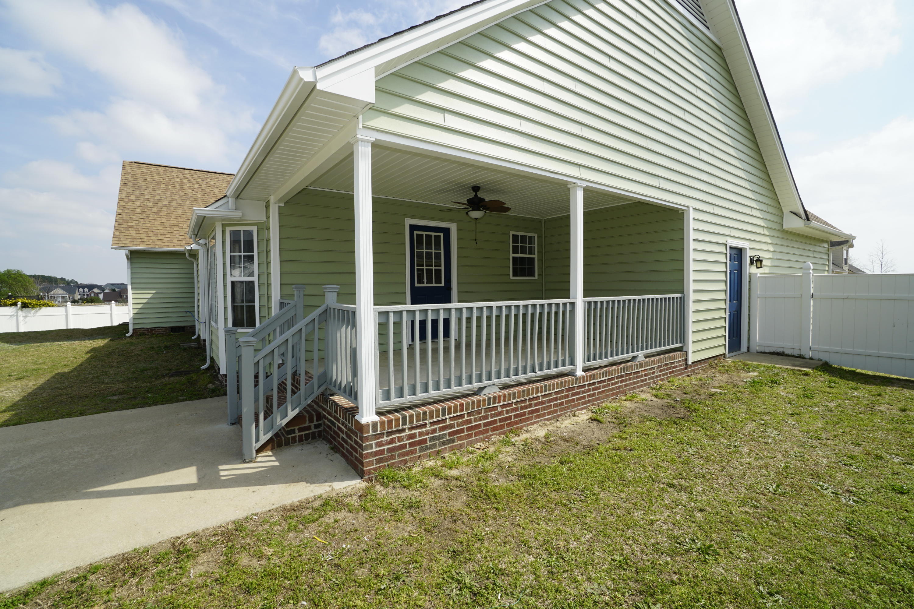 107 Cherian Court Pooler, GA 31322 - Photo 47 of 50 Great covered patio with ceiling fan. Concrete pad would be a great place for the grill! Garage service door is in far right of picture, near fence.