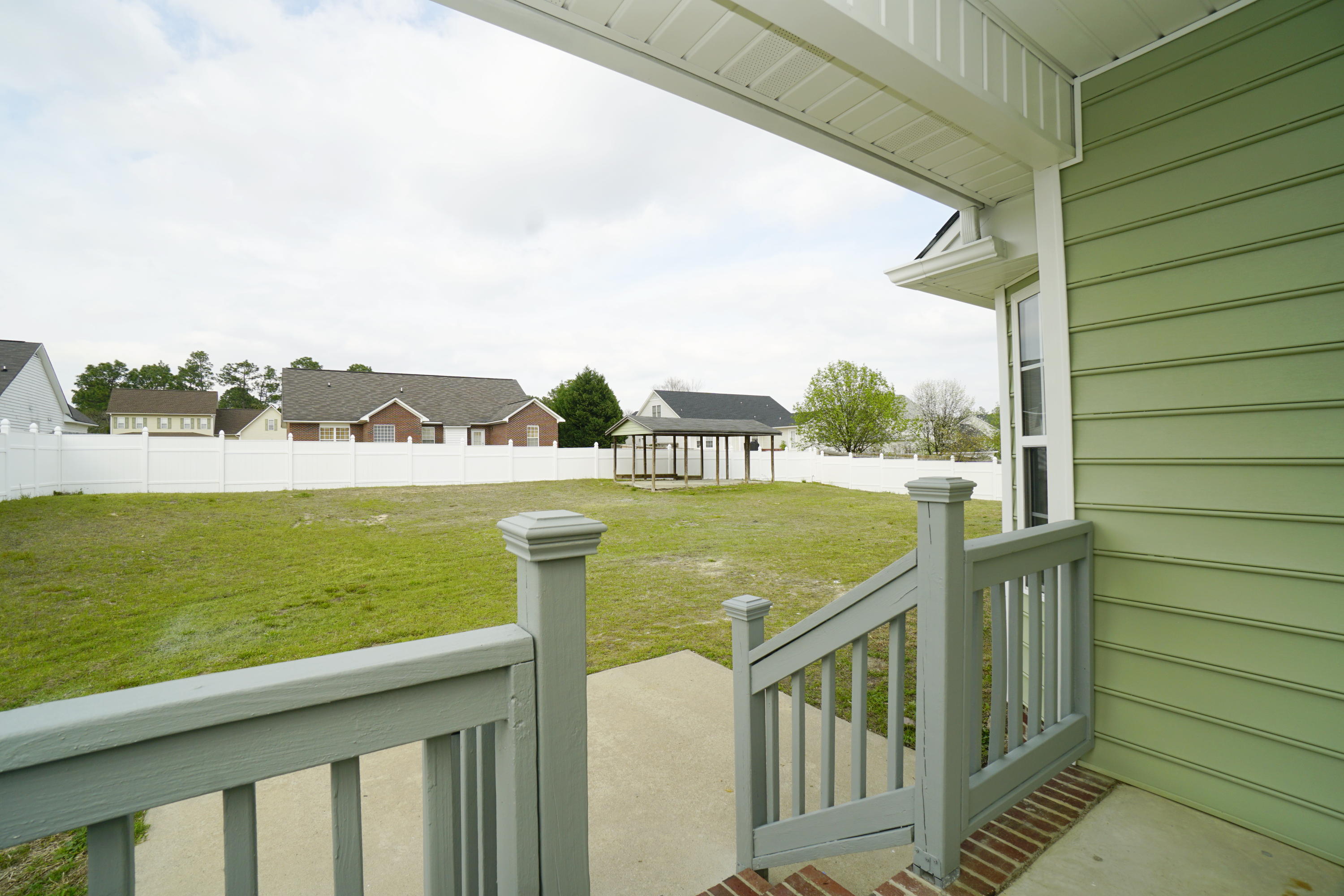 107 Cherian Court Pooler, GA 31322 - Photo 48 of 50 Overlooking the large, private backyard from the covered patio. Another covered area in the back part of the yard.
