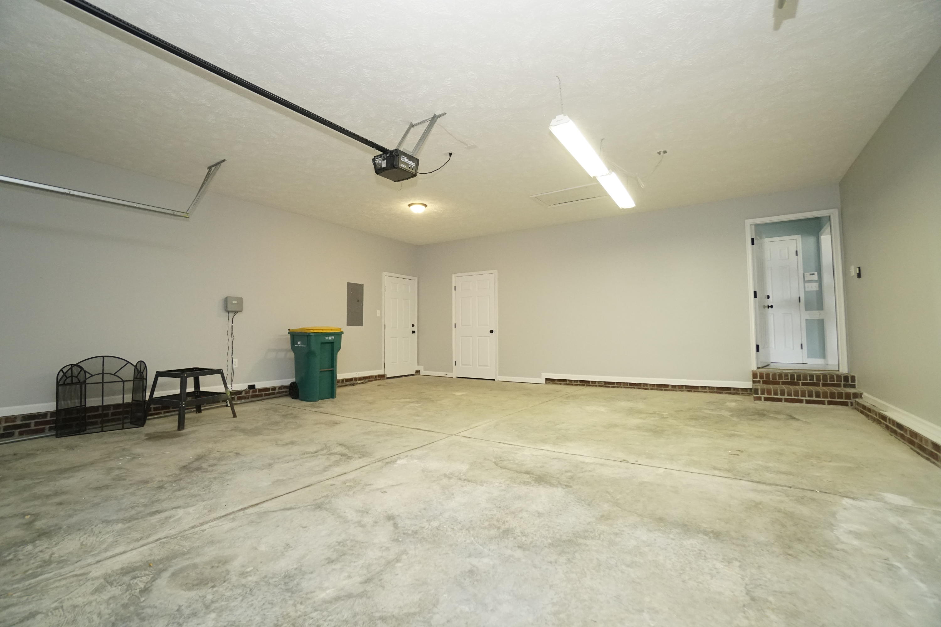 107 Cherian Court Pooler, GA 31322 - Photo 50 of 50 From front of garage looking in. Door on left is service door to yard; door in center is small closet with water heater; door on right with steps leads to kitchen area.