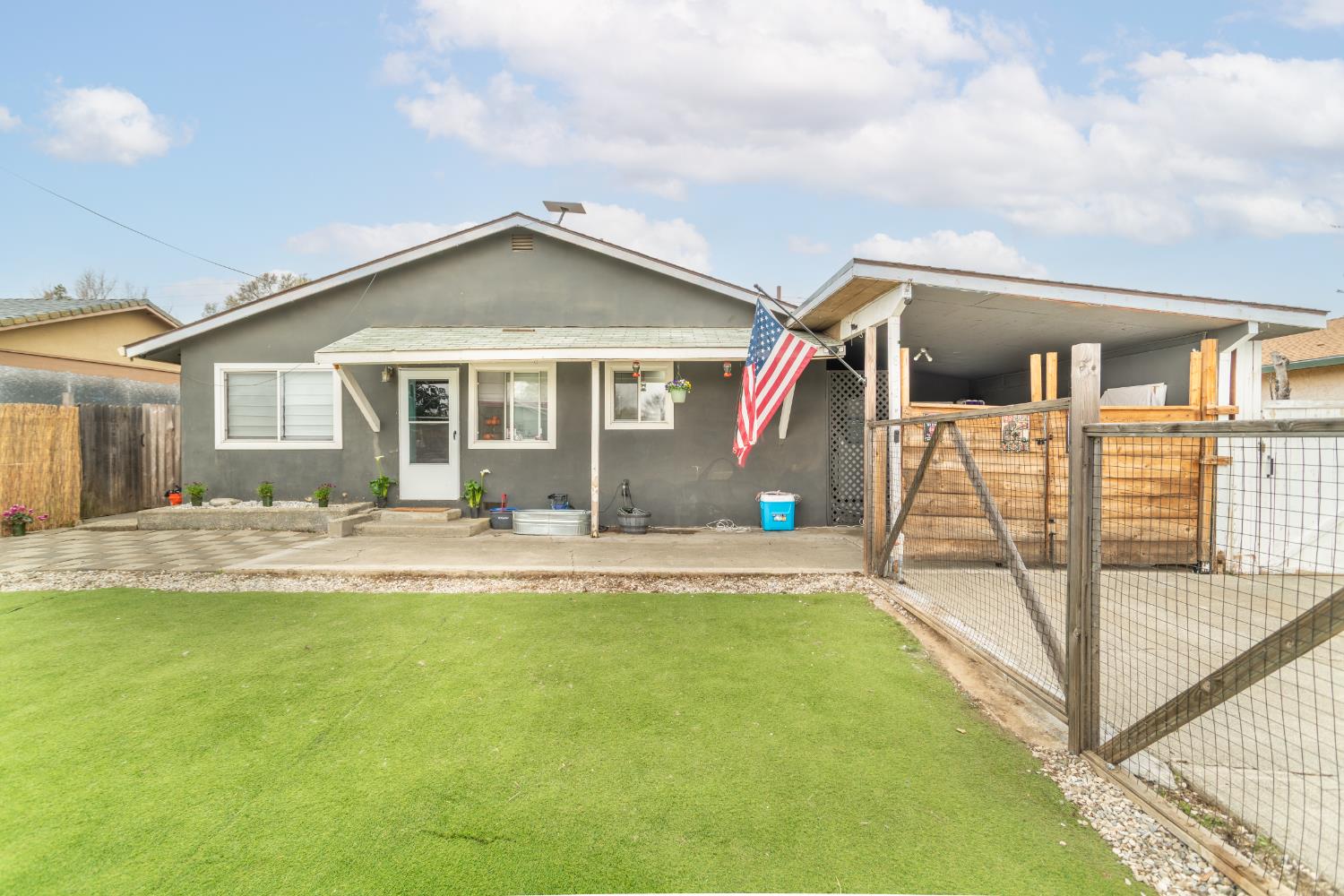 view of front of home with a gate and stucco siding