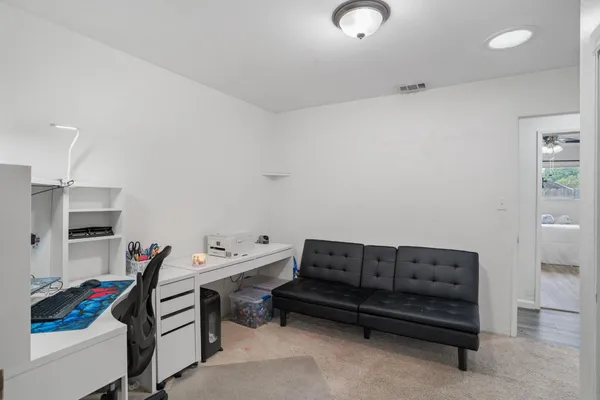 a bathroom with a sink a toilet and shower curtain