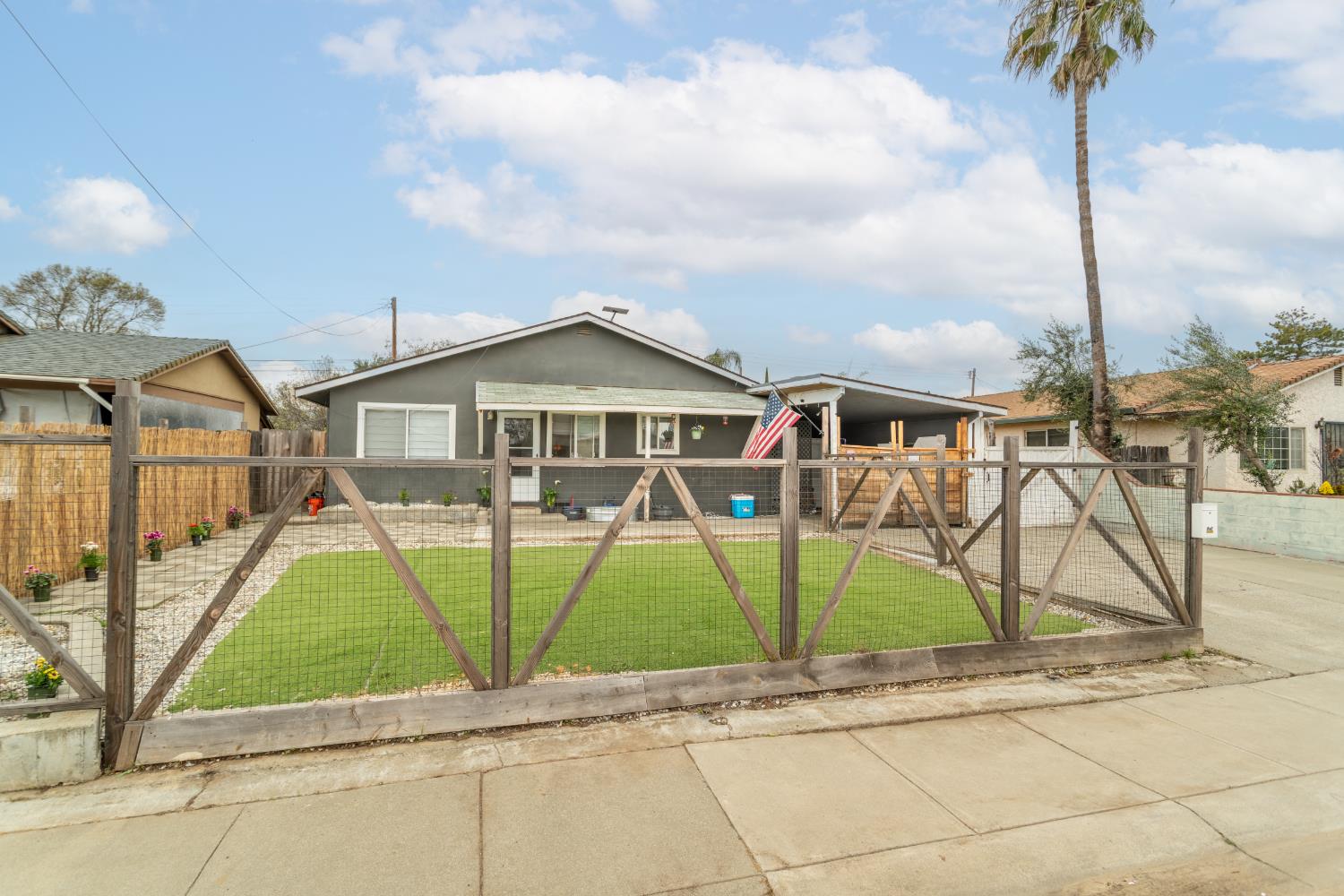 832 Jackson Street Winters, CA 95694 - Photo 4 of 41 view of front of house with a fenced front yard, stucco siding, and a gate