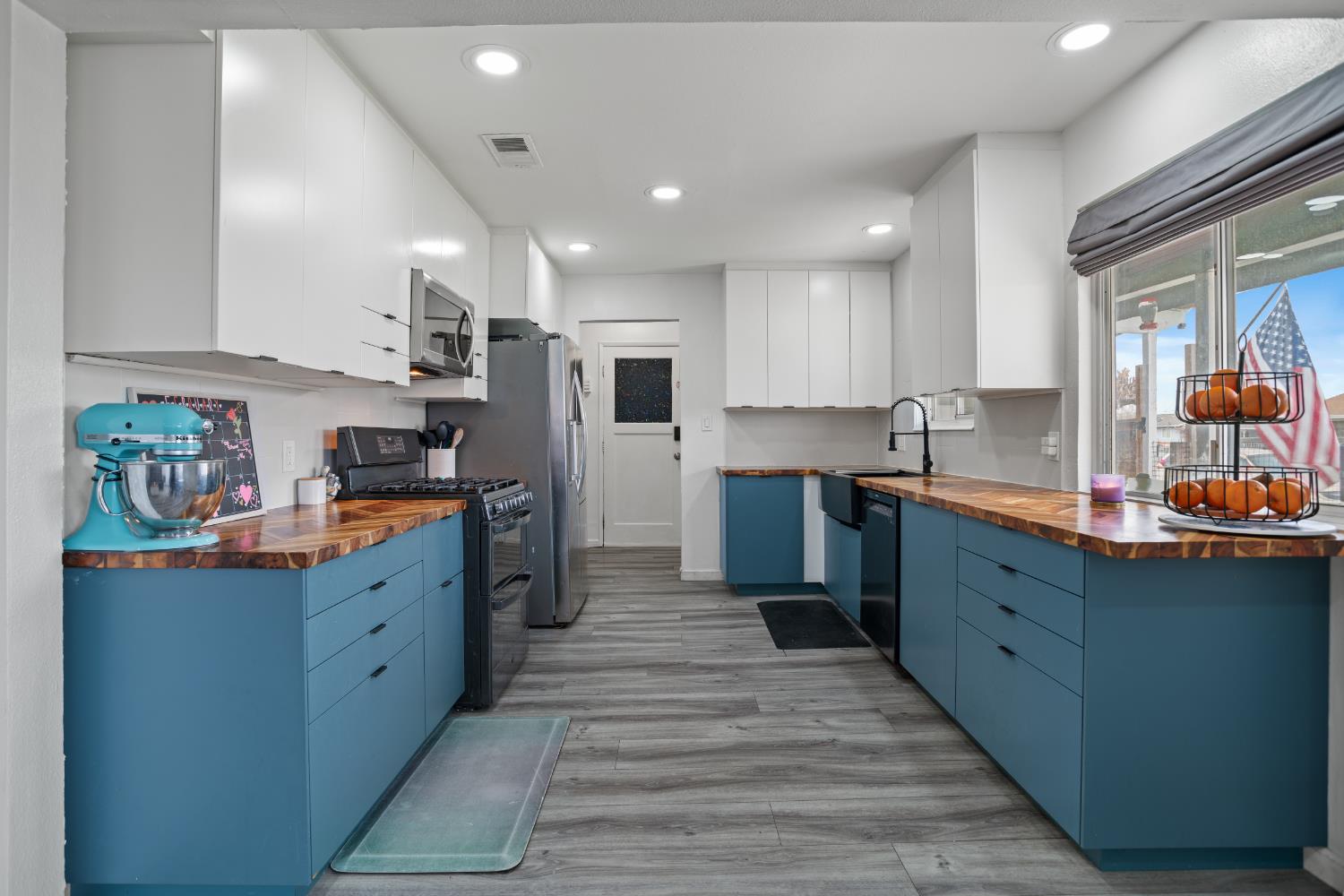 832 Jackson Street Winters, CA 95694 - Photo 7 of 41 kitchen featuring dual tone cabinetry, wooden counters, black appliances, recessed lighting, and light wood-style floors