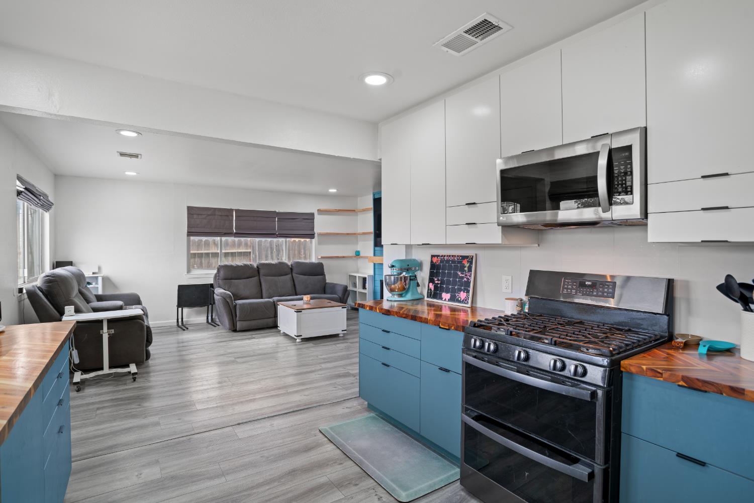 832 Jackson Street Winters, CA 95694 - Photo 41 of 41 kitchen featuring butcher block counters, double oven range, open floor plan, stainless steel microwave, and two tone cabinets