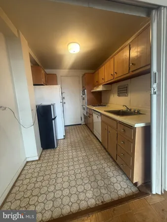 a kitchen with stainless steel appliances granite countertop a refrigerator and a stove