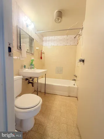 a bathroom with a toilet a sink and bathtub