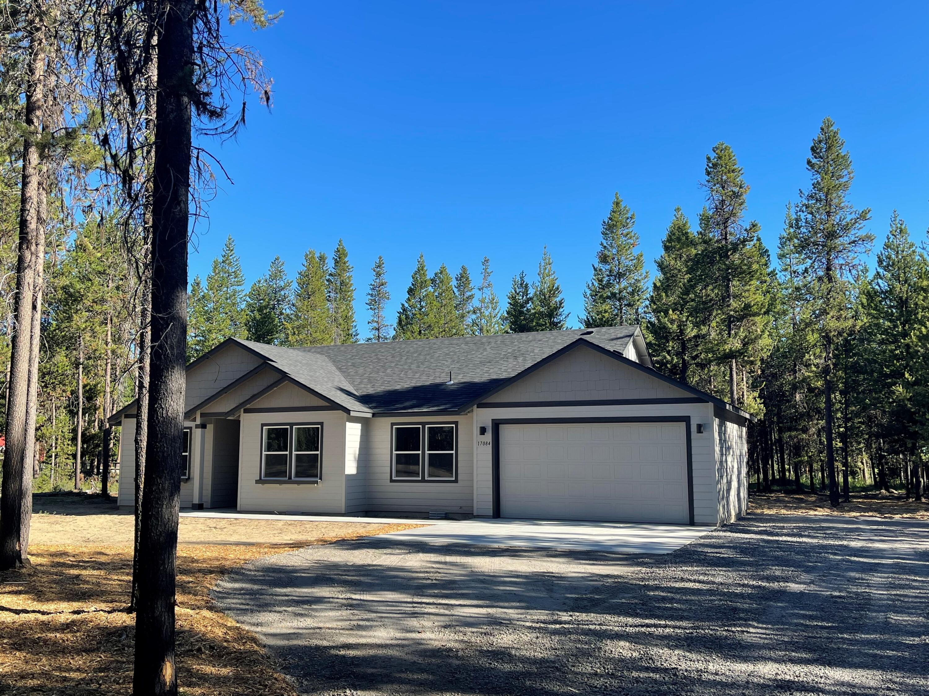 17084 Indio Road Bend, OR 97707 - Photo 1 of 40 a front view of a house with a yard and garage