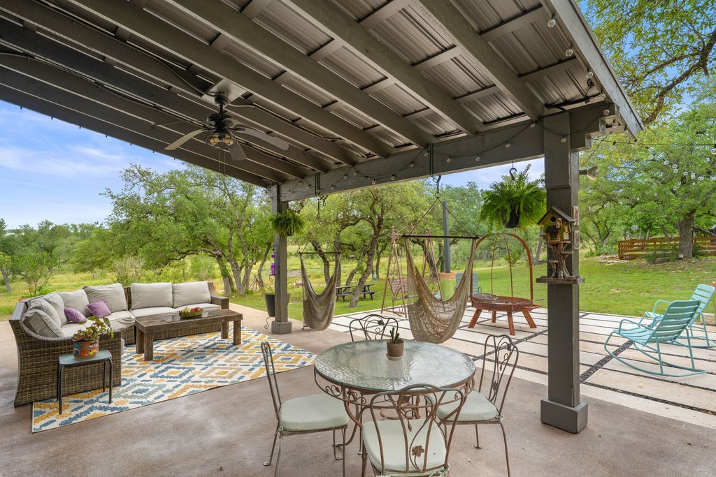 290 Sunset Ridge Dripping Springs, TX 78620 - Photo 34 of 36 An inviting covered patio offers ample space for outdoor living and recreation.
