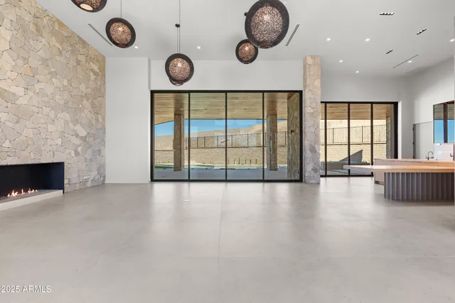 an empty room with a fireplace and a large window