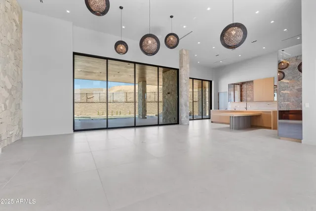 a spacious bathroom with a tub double vanity and mirrors