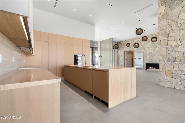 a spacious bathroom with a granite countertop sink a large mirror and a bathtub