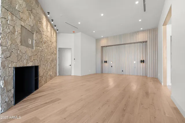 a large bed sitting in a bedroom next to a window