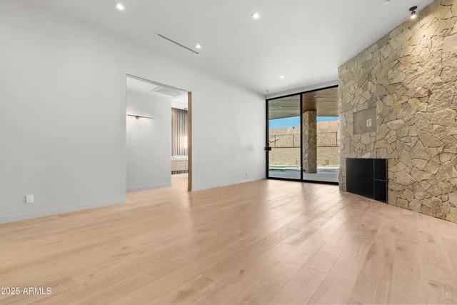 a living room with furniture and a floor to ceiling window