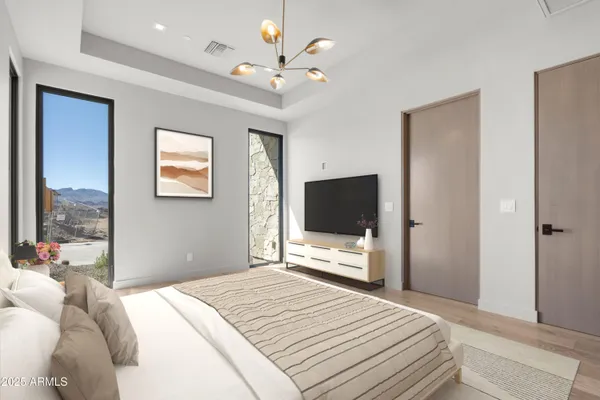 a bedroom with a bed and a flat screen tv