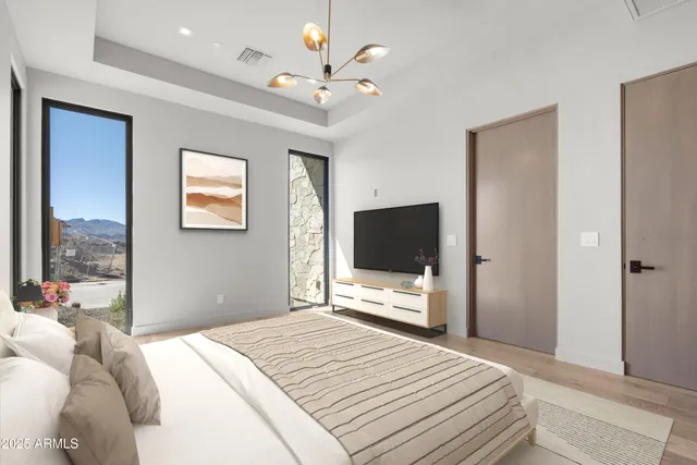 a bedroom with a bed and a flat screen tv