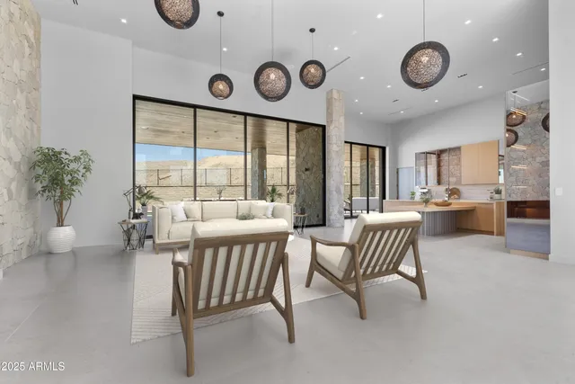 a living room with furniture a large window and a clock