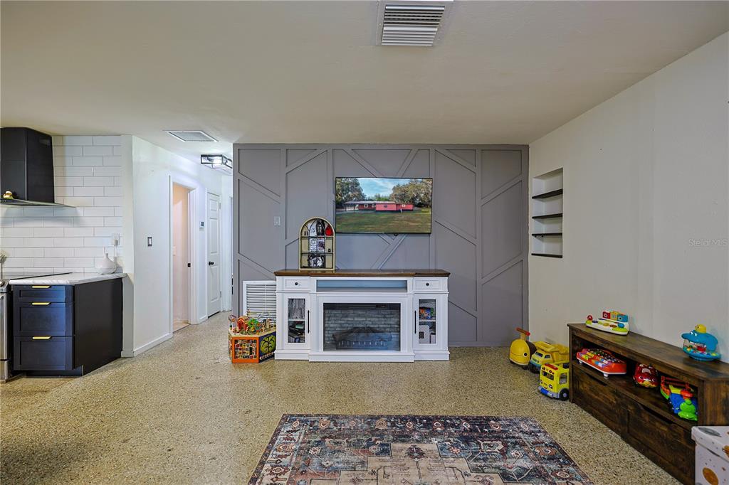 613 Scenic Street Leesburg, FL 34748 - Photo 11 of 38 a living room with furniture and a fireplace
