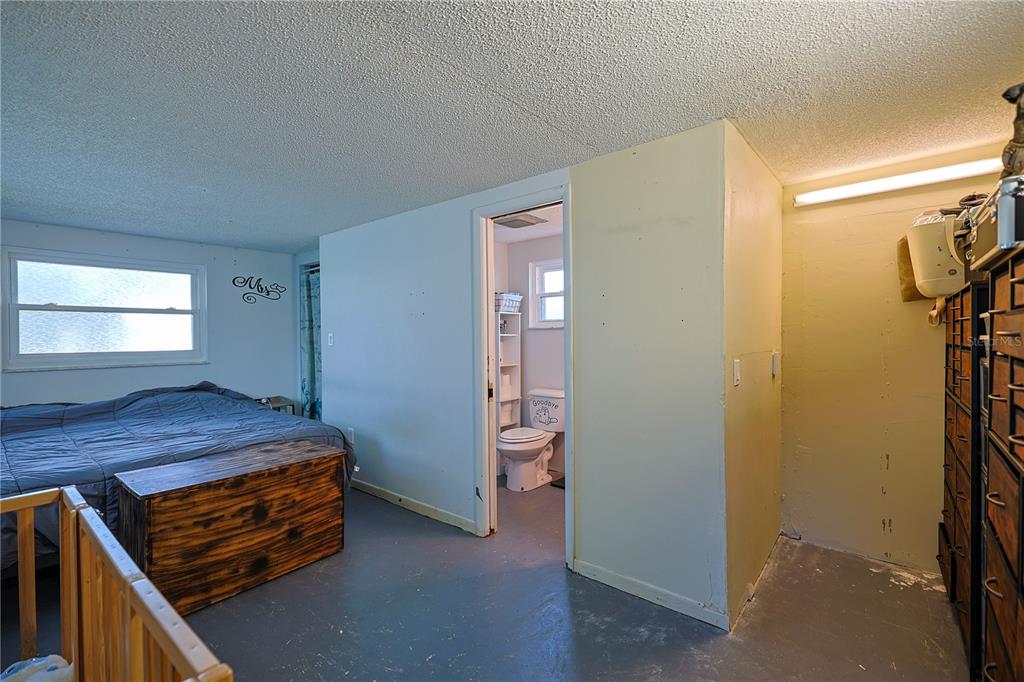 613 Scenic Street Leesburg, FL 34748 - Photo 14 of 38 a bedroom with a bed and a window