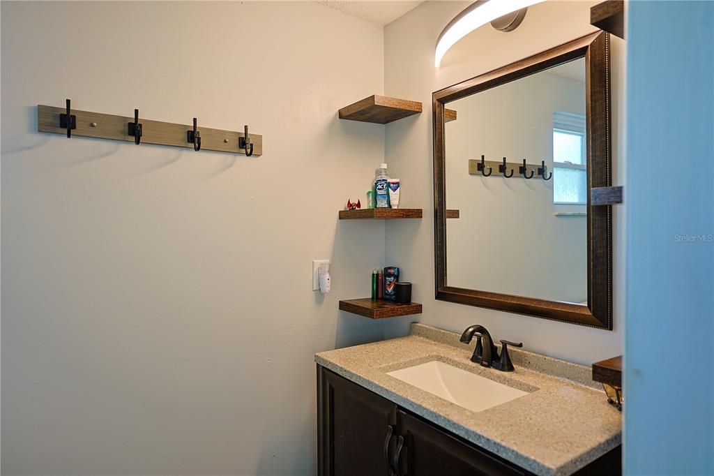 613 Scenic Street Leesburg, FL 34748 - Photo 15 of 38 a bathroom with a sink and mirror