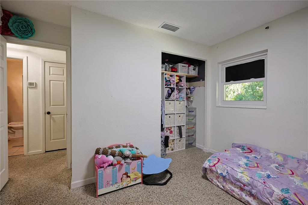 613 Scenic Street Leesburg, FL 34748 - Photo 17 of 38 a bedroom with a bed and a window