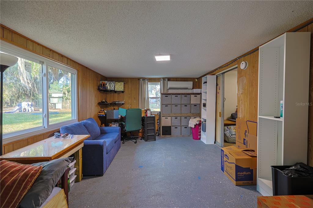613 Scenic Street Leesburg, FL 34748 - Photo 22 of 38 a living room filled with furniture and a large window
