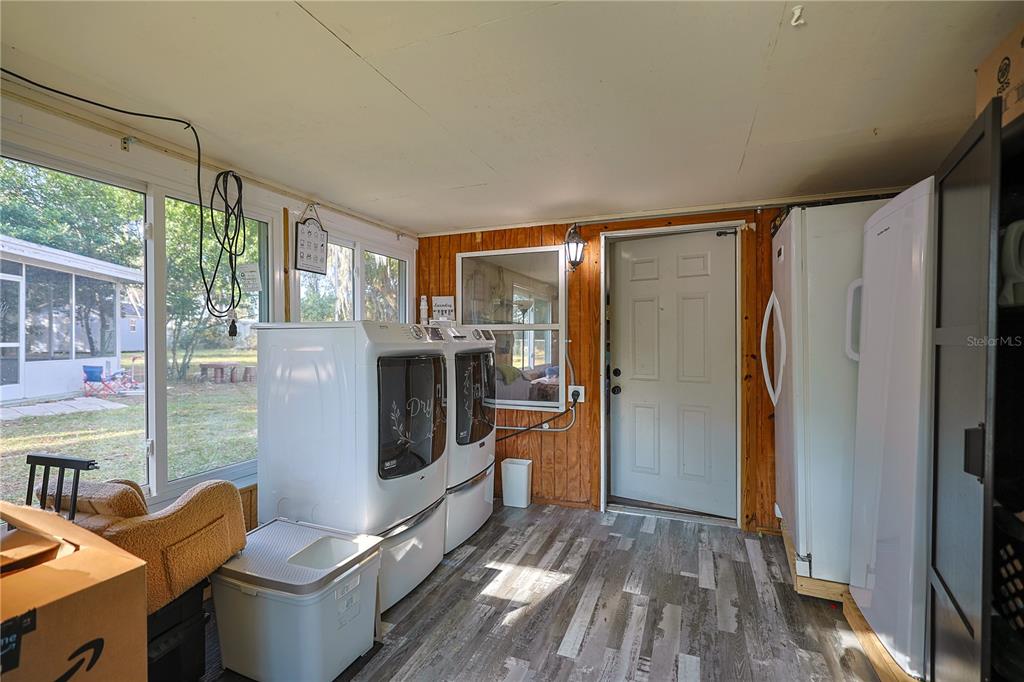 613 Scenic Street Leesburg, FL 34748 - Photo 24 of 38 a view of kitchen with furniture and refrigerator
