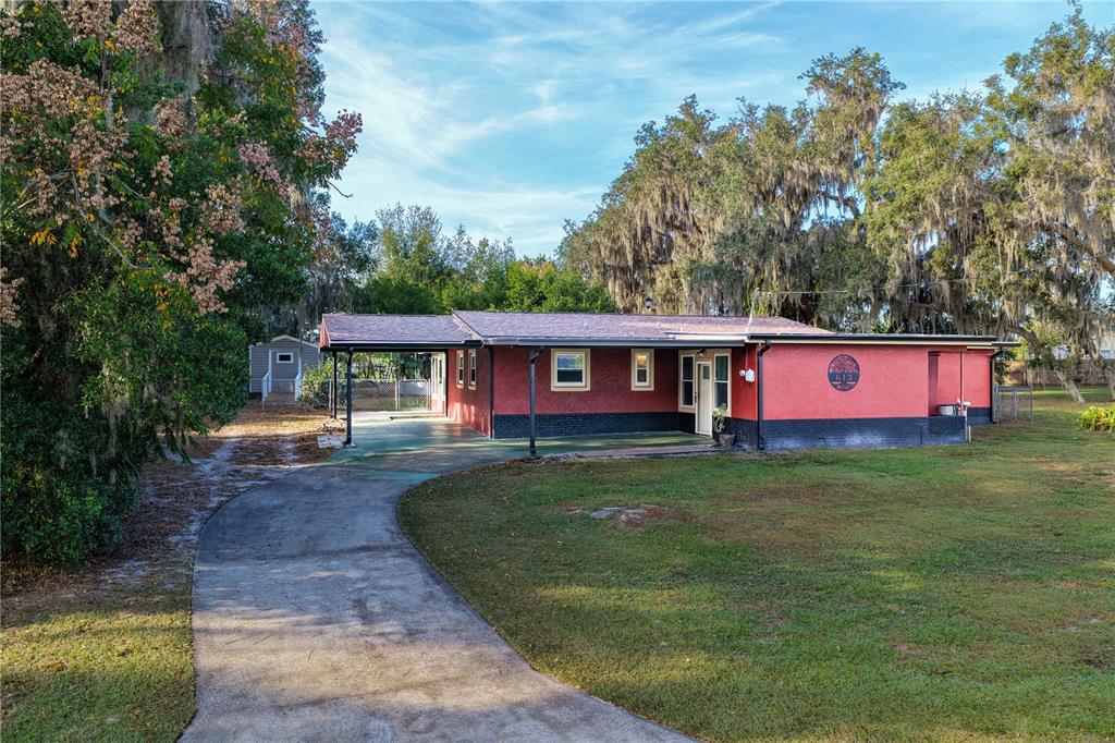 613 Scenic Street Leesburg, FL 34748 - Photo 32 of 38 a view of a house with a yard