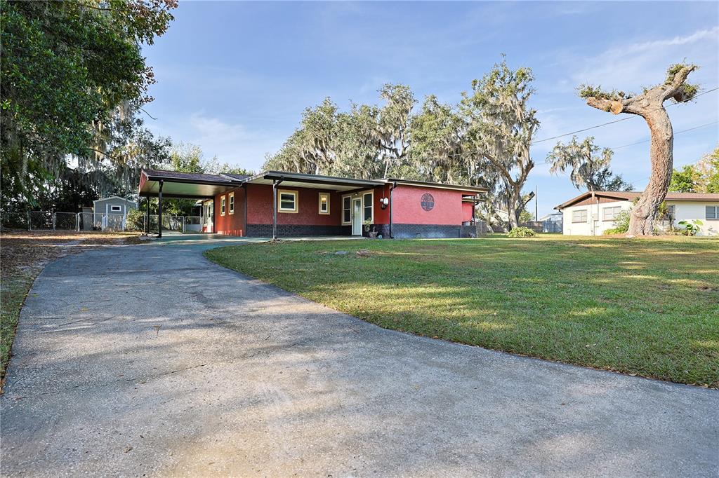 613 Scenic Street Leesburg, FL 34748 - Photo 33 of 38 a view of a house with a yard
