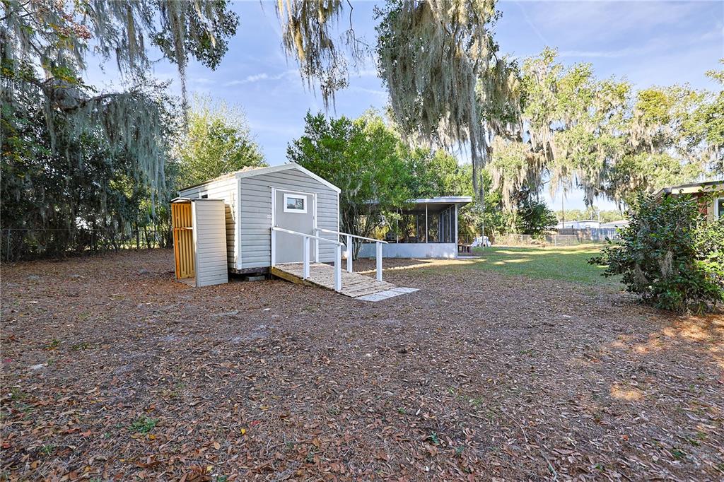 613 Scenic Street Leesburg, FL 34748 - Photo 36 of 38 a view of a house with a yard and large trees