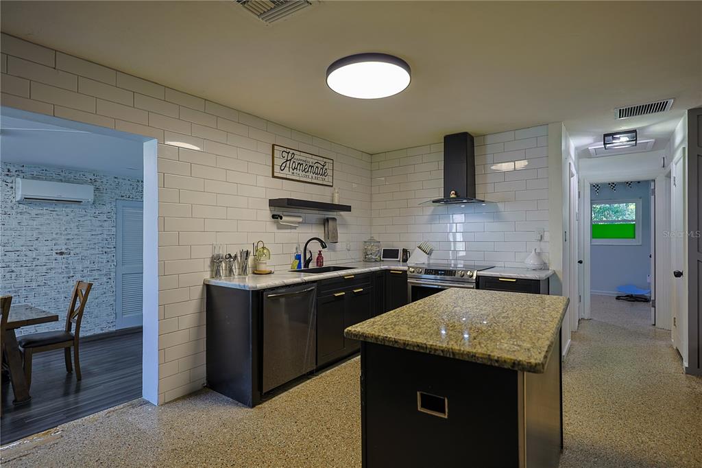 613 Scenic Street Leesburg, FL 34748 - Photo 5 of 38 a kitchen with a sink and cabinets