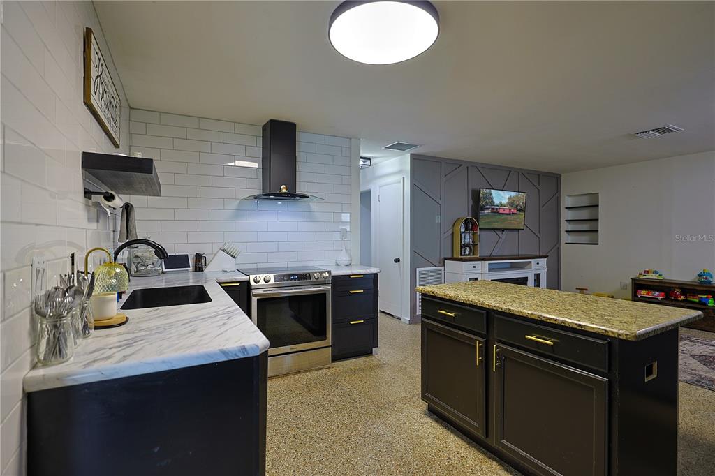613 Scenic Street Leesburg, FL 34748 - Photo 9 of 38 a kitchen with a sink stove and refrigerator