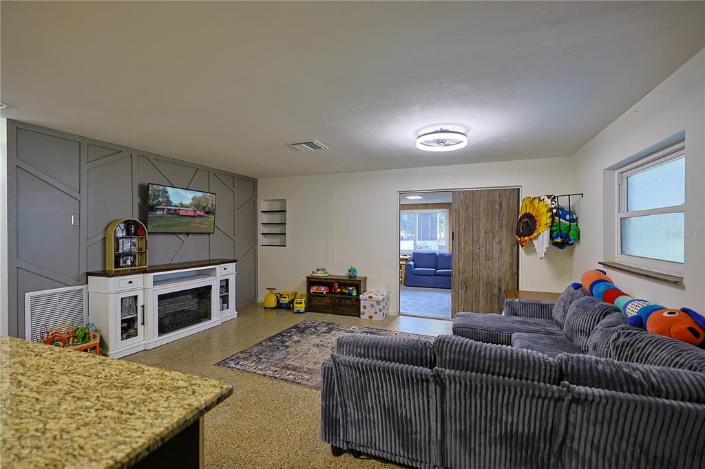 613 Scenic Street Leesburg, FL 34748 - Photo 10 of 38 a living room with furniture and a fireplace
