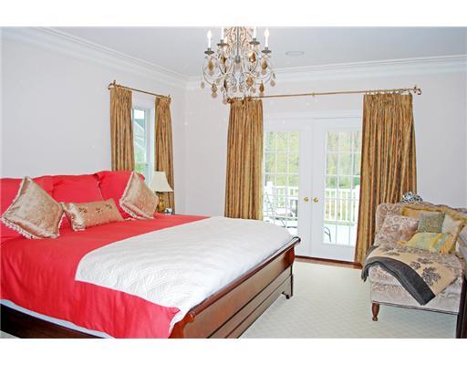 631 Long Ridge Road, Unit 37 Stamford, CT 06902 - Photo 10 of 10 a bedroom with a large bed and a chandelier