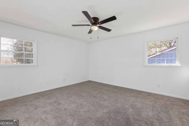 a view of room with window and ceiling fan