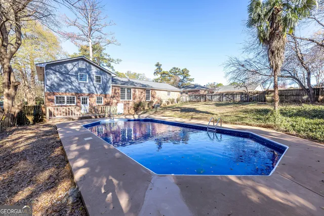 a view of a swimming pool with an outdoor space and seating area
