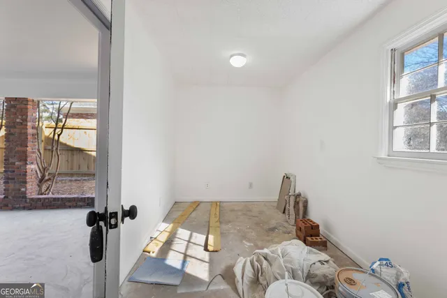 a bed sitting in a bedroom next to a window