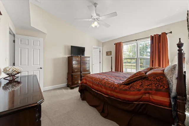 a bed sitting in a bedroom next to a window