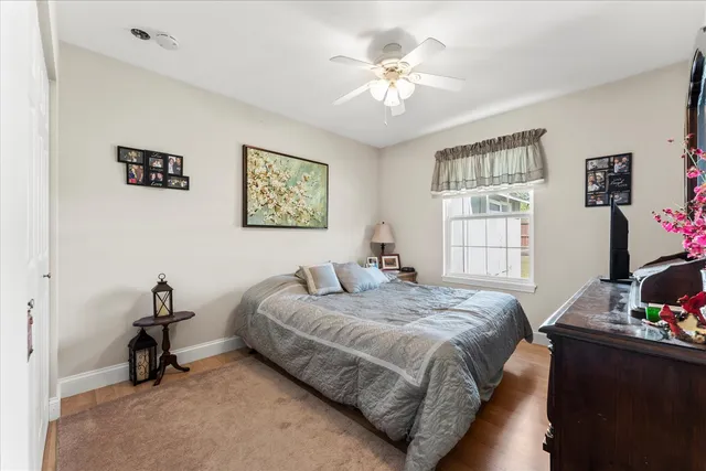 a spacious bedroom with a bed and a window