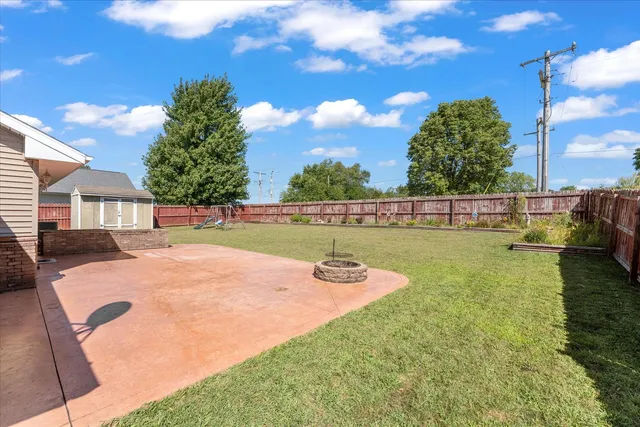a view of backyard with swimming pool and seating