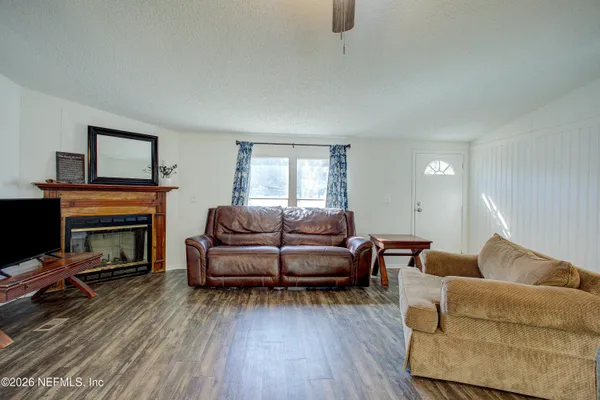 a living room with furniture and a fireplace
