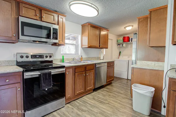 a kitchen with a sink stove and microwave