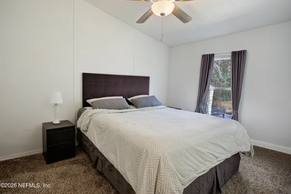 a bedroom with a bed and a window