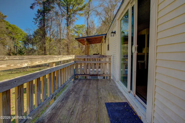 a view of balcony with wooden floor