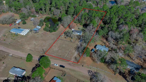 an aerial view of a house with a yard