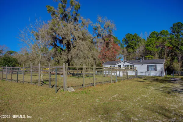 a view of house with swimming pool outdoor seating